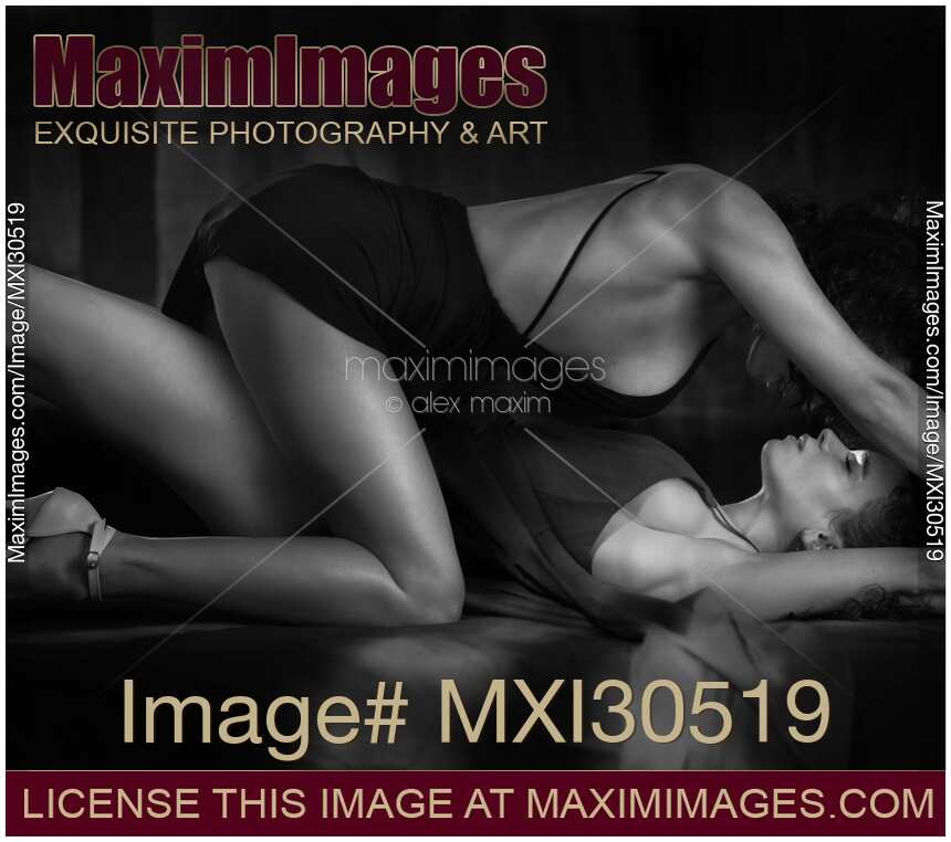 Romantic sensual lesbian couple Two beautiful sexy women making love on a bed Black and white
