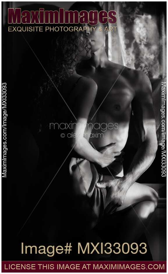 Romantic sensual portrait of a sexy couple embracing in dark indoor settings Black and white