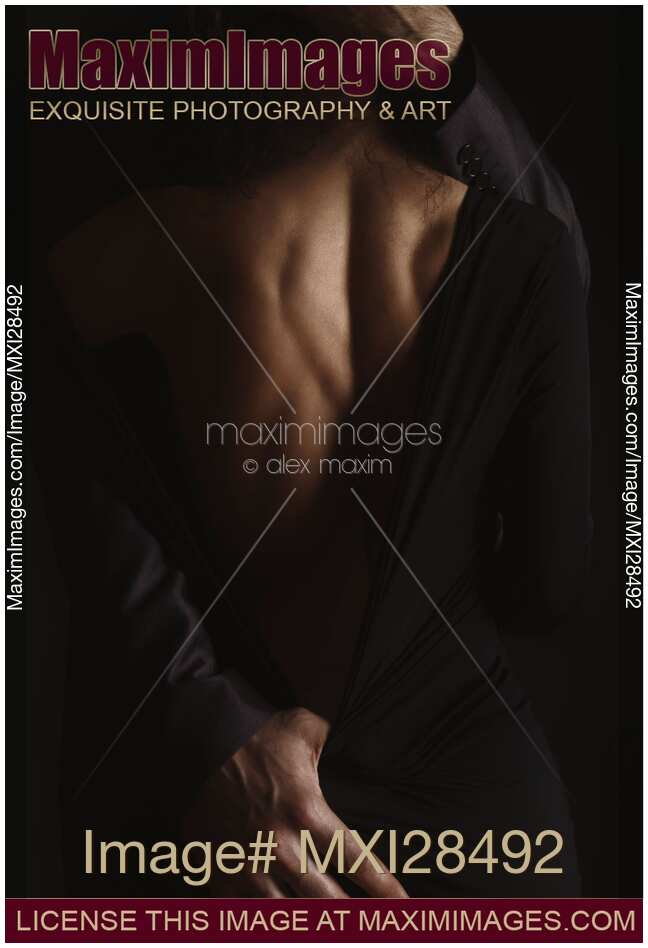 Romantic sensual portrait of couple embracing in dim dramatic light