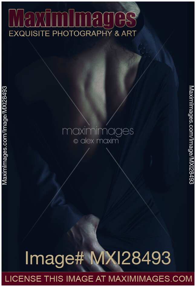 Romantic sensual portrait of couple embracing in dim night light