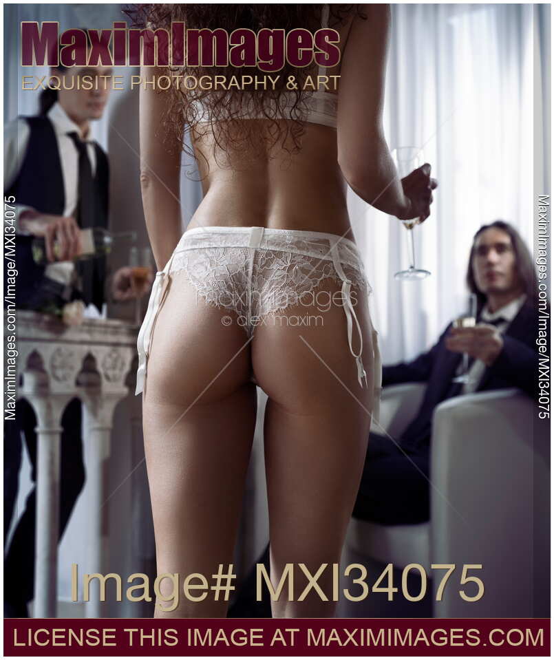 Romantic trio, provocative photo of a sexy woman in white lingerie with a glass of wine joining a party of two gentlemen admiring her