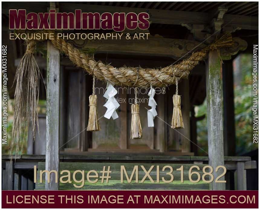 Rural Shinto shrine detail Shimenawa rope and paper Shide in Japan