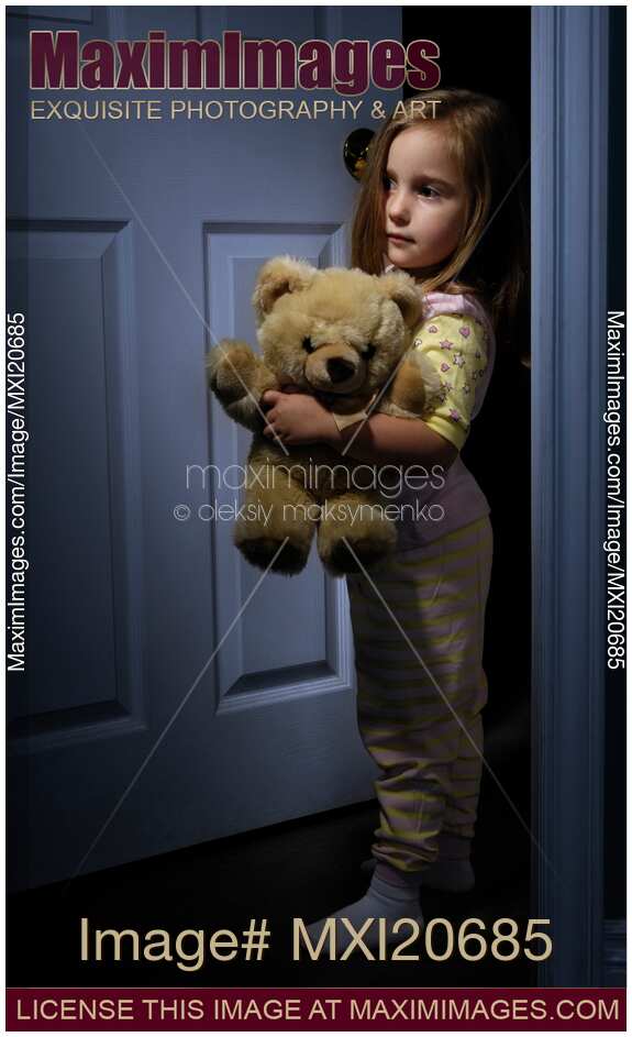 Scared Little Girl Home Alone at Night with a Teddy Bear