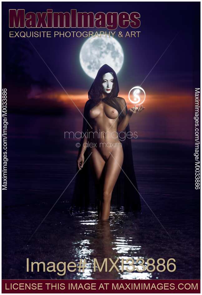 Seductive mysterious snake-like woman in white face mask with sensual nude body walking out of the water like a goddess in full moon