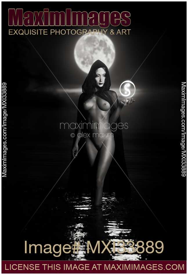 Seductive mysterious woman in white face mask with sensual nude body walking out of the water like a goddess in full moon Black and white
