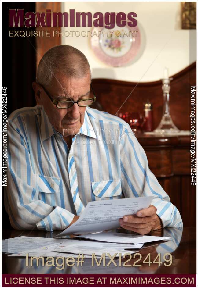 Senior Looking Through Bills