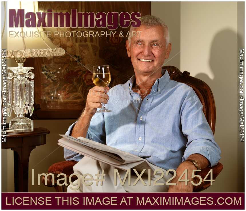 Senior Sitting in a Chair with a Glass of Wine
