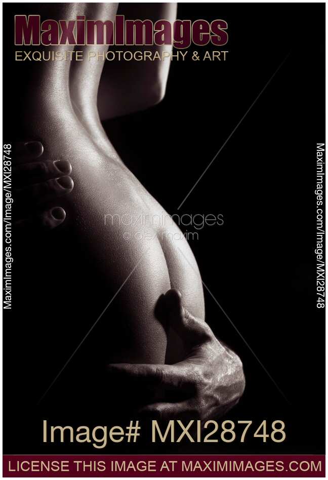 Sensual art nude closeup of woman body with man hand around her bottom