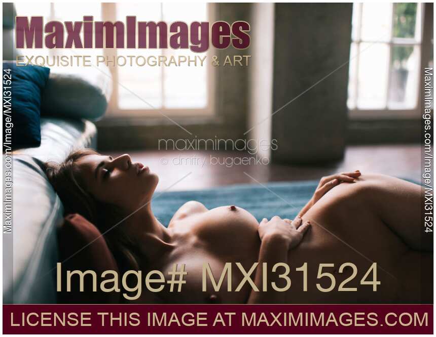 Sensual artistic nude portrait of a woman lying naked on the floor