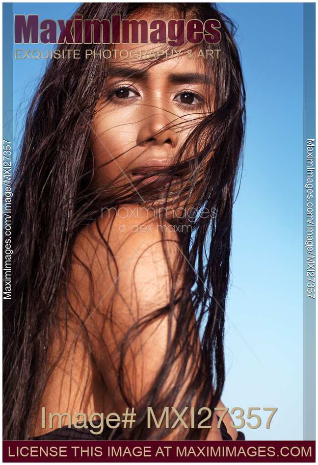 Sensual beauty portrait of young exotic woman with long wet dark hair