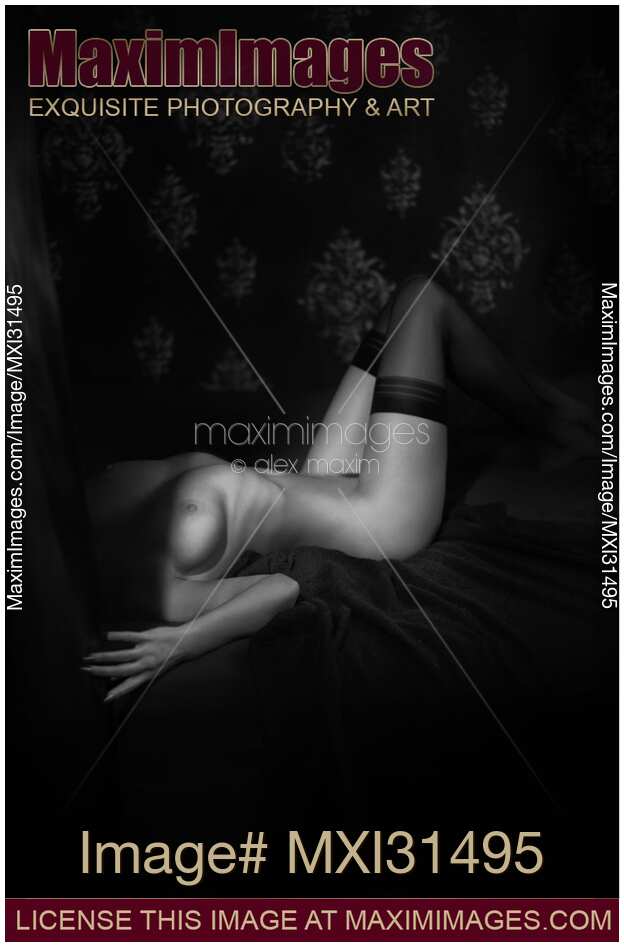 Sensual body of a woman lying in bed naked wearing only stockings Black and white art nude