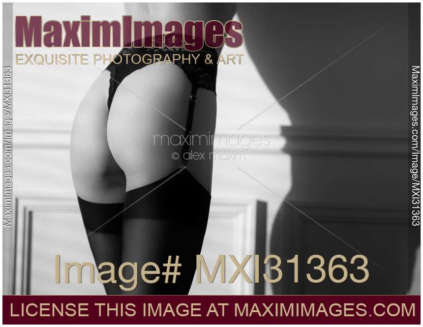 Sensual body parts of a woman wearing sexy black lingerie and stockings black and white closeup of butt