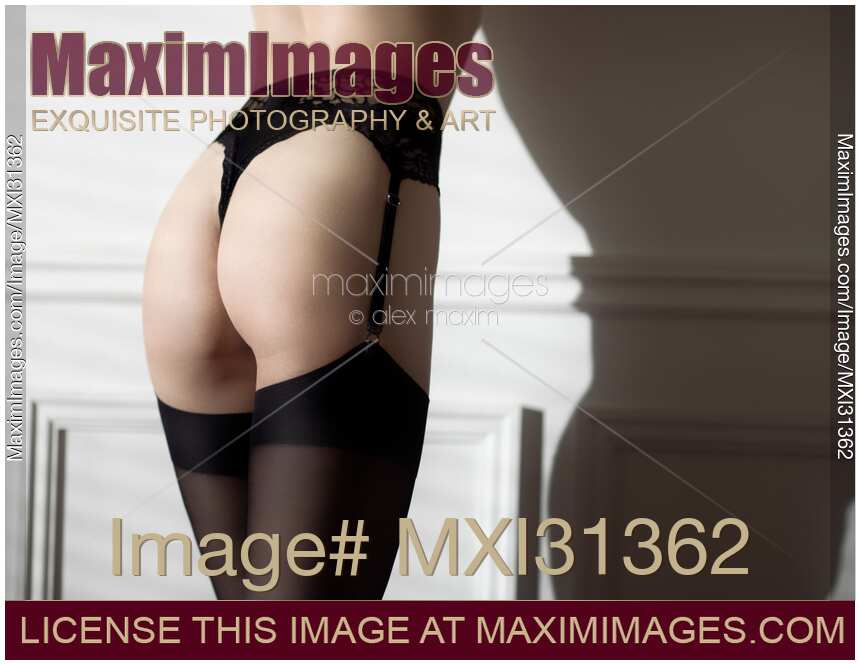 Sensual body parts of a woman wearing sexy black lingerie and stockings closeup of butt
