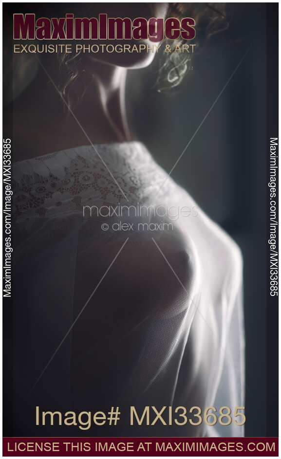 Sensual boudoir closeup of woman sexy breasts under sheer see-through white nightgown