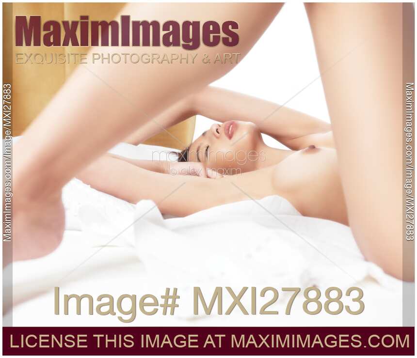 Sensual closeup of a naked woman lying in bed