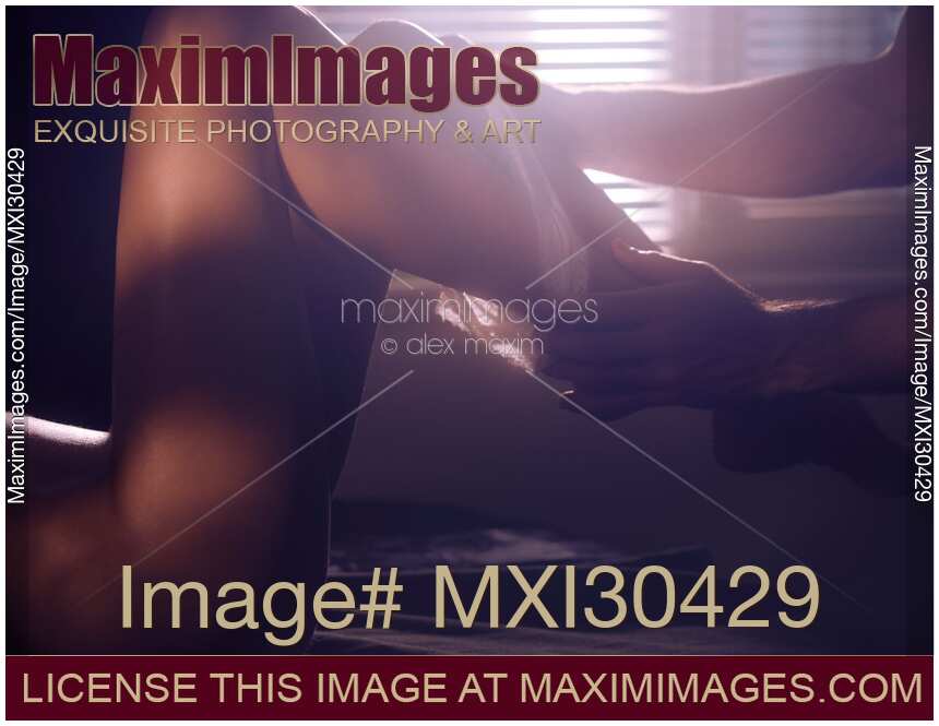 Sensual closeup of couple making love Man hands pulling down underwear from sexy woman legs