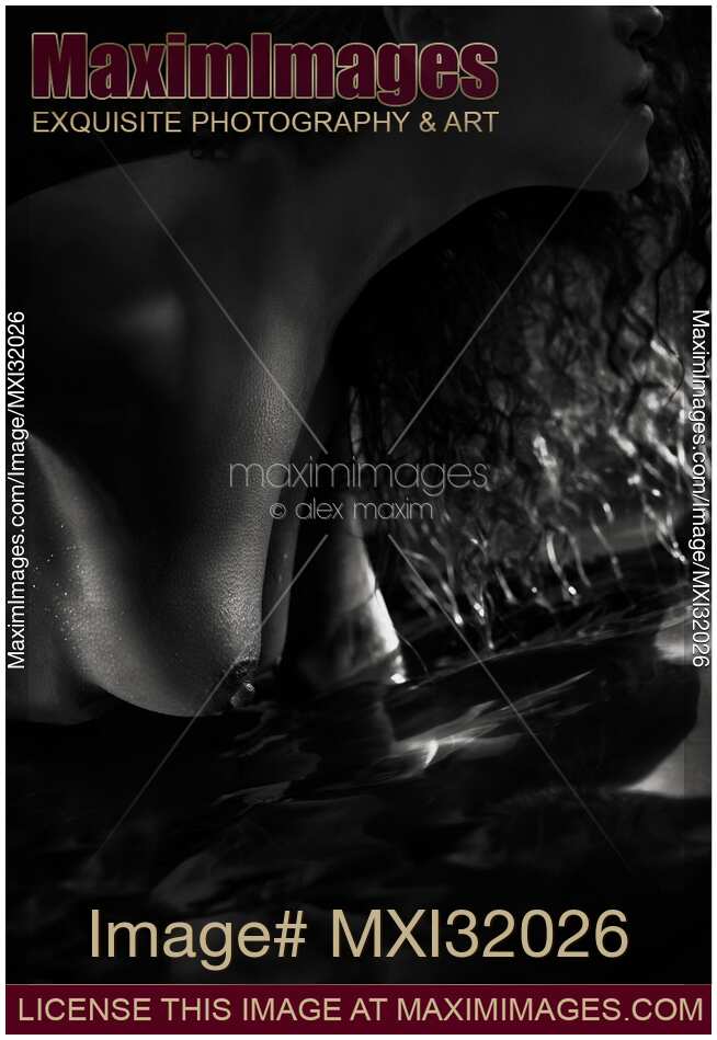 Sensual closeup of nude woman breasts touching water Black and white