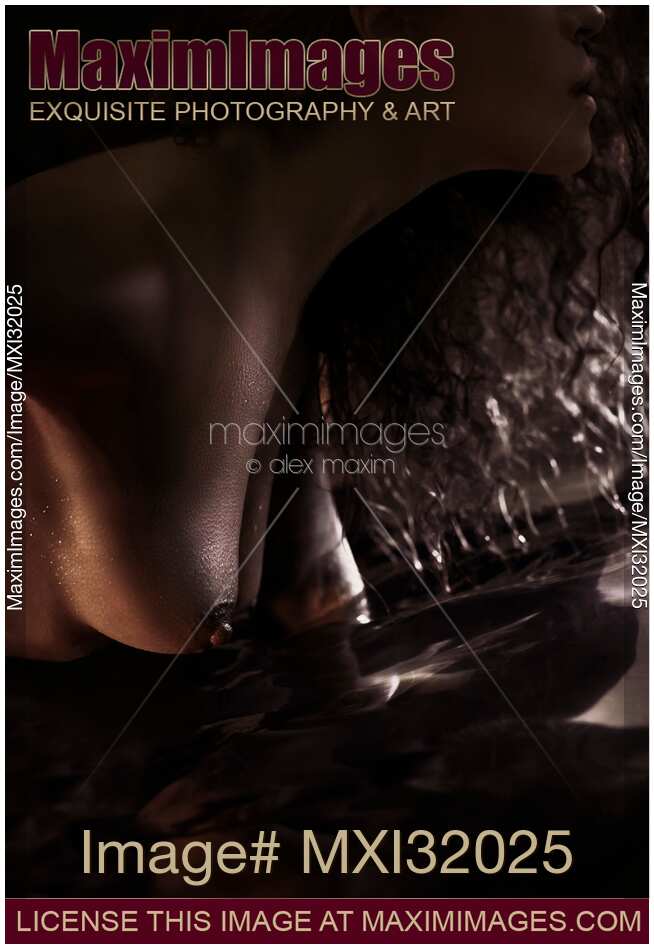 Sensual closeup of nude woman breasts touching water