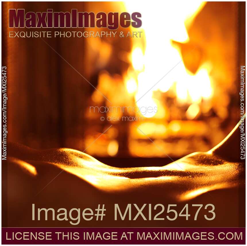 Sensual closeup of nude woman in front of fireplace