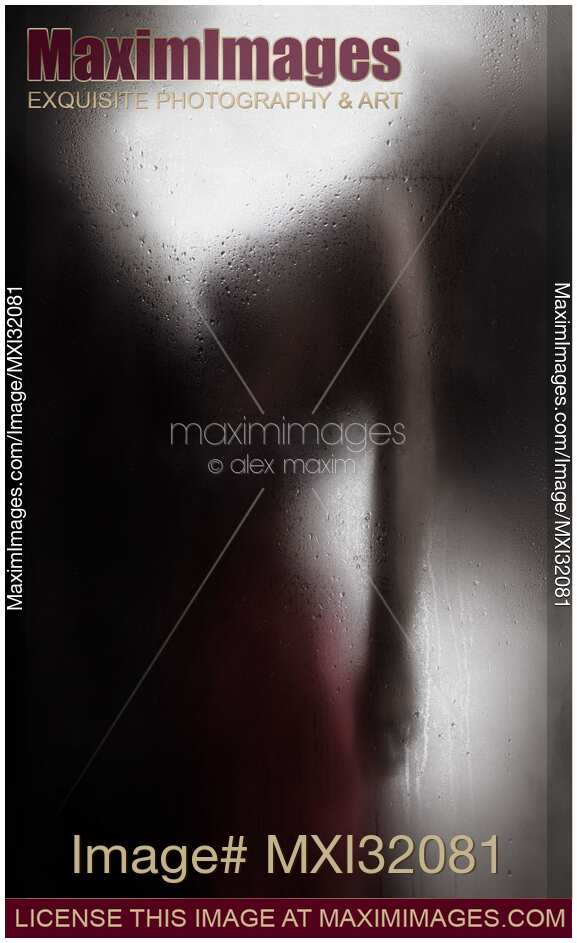 Sensual couple behind wet glass man holding a woman by the waist