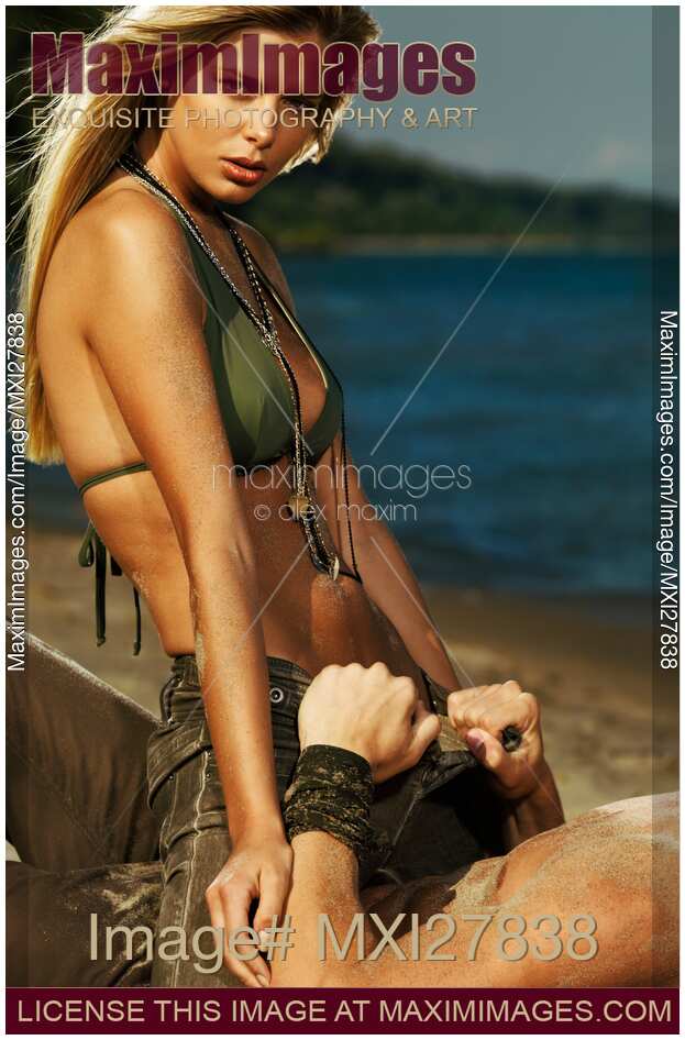 Sensual couple portrait at a sandy beach