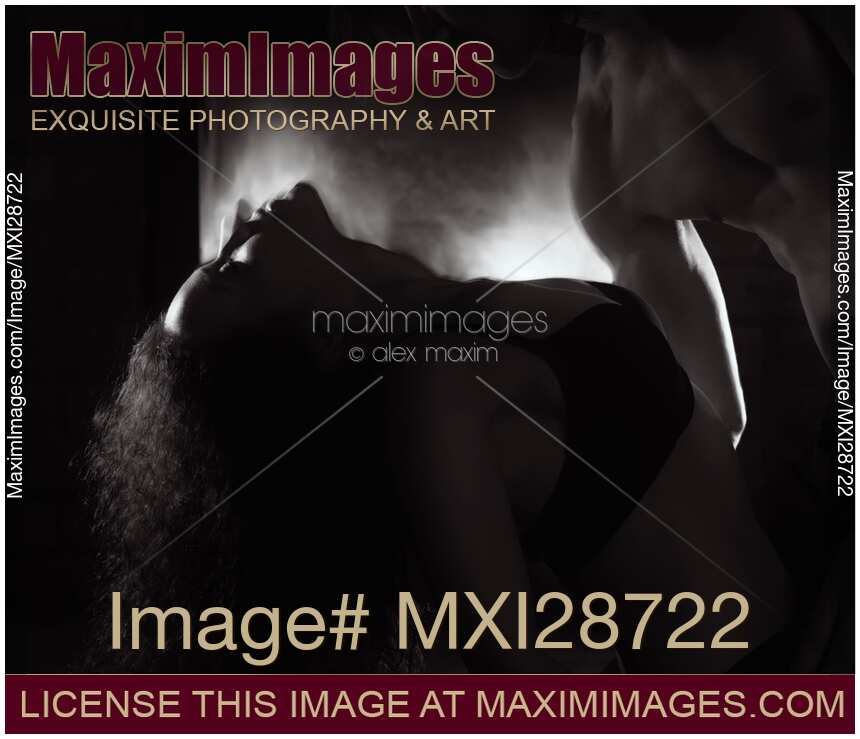 Sensual dynamic photo of couple making love in front of fireplace Black and white