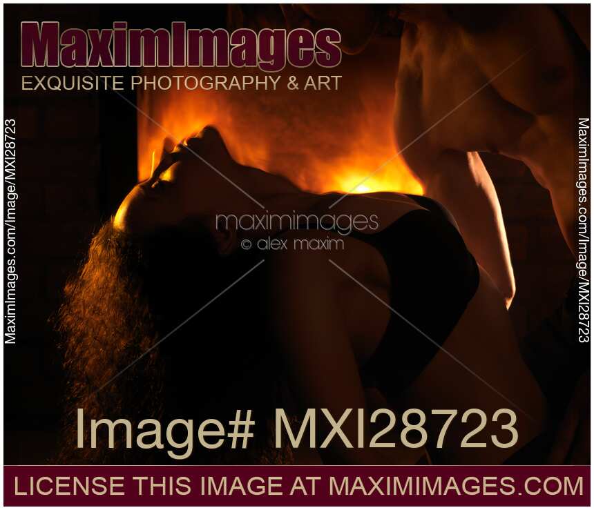 Sensual dynamic photo of couple making love in front of fireplace