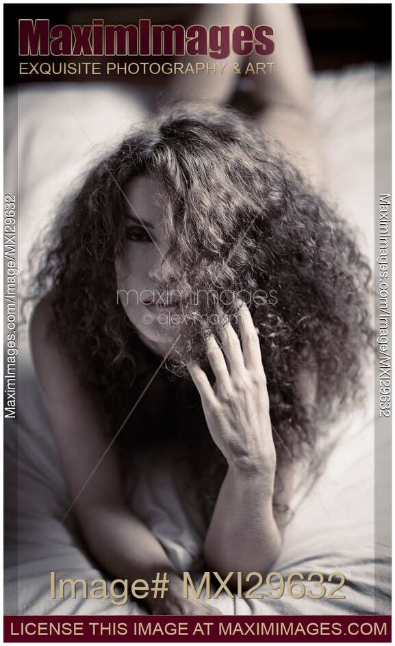 Sensual expressive portrait of a woman lying on a bed