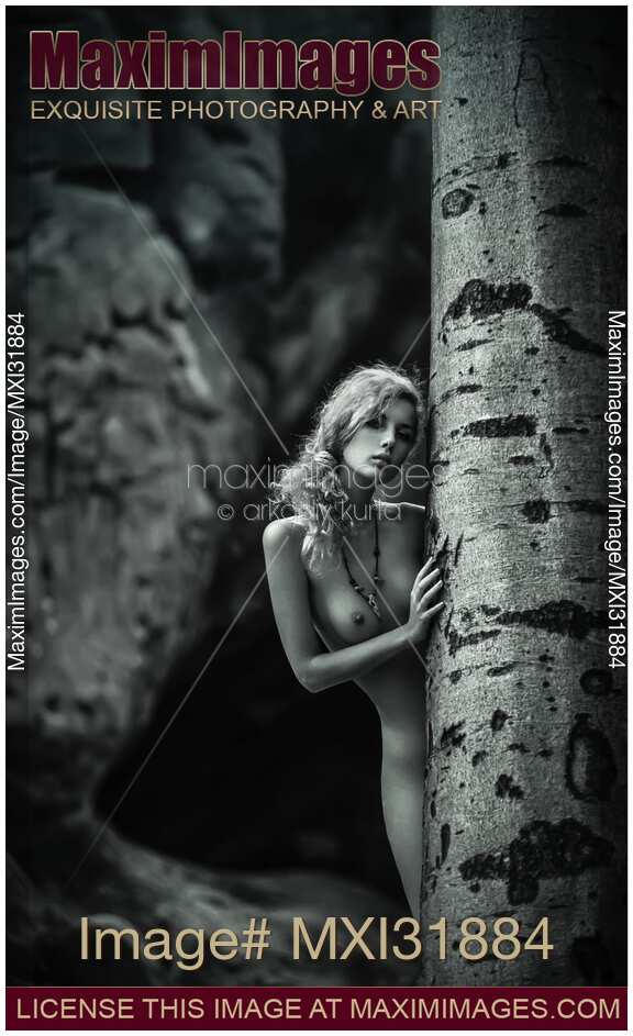Sensual fine art black and white nude of a young girl in the forest
