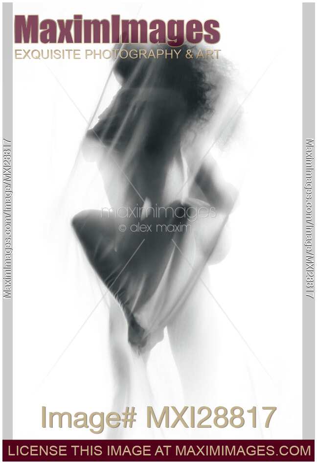 Sensual nude couple making love in glowing white mist