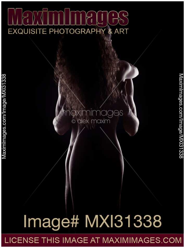 Sensual nude couple standing in an embrace naked bodies silhouette on black background