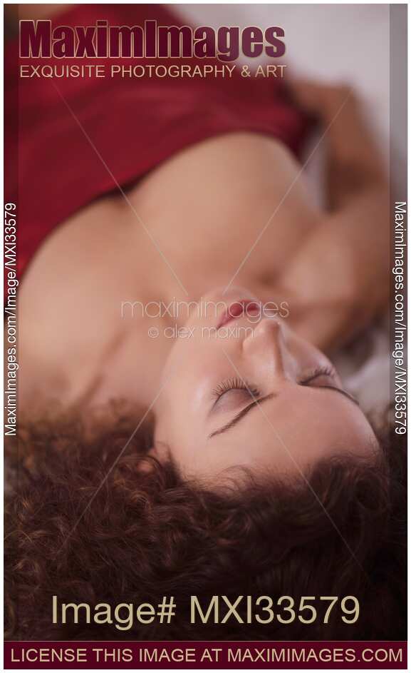 Sensual portrait of a beautiful woman closeup of face with closed eyes with delicate features lying in bed sleeping