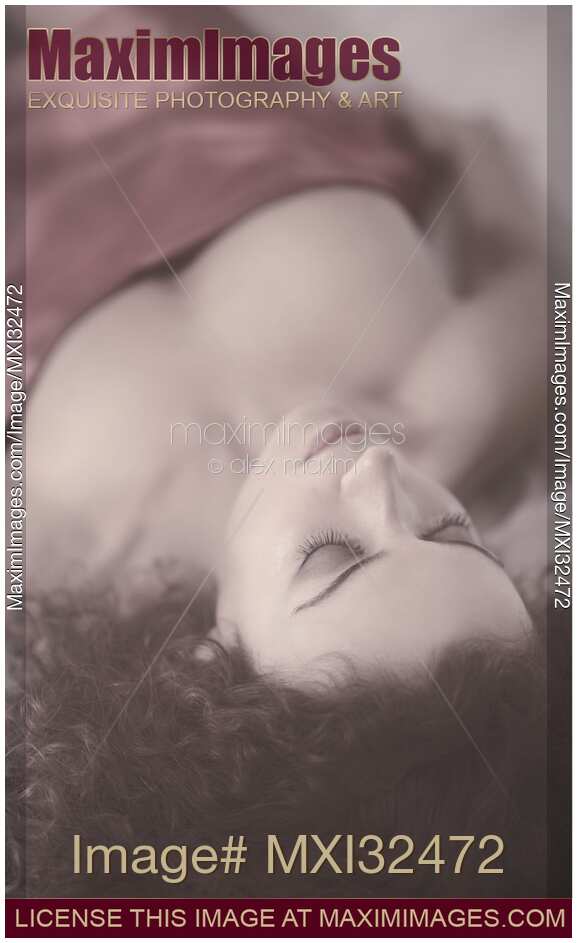 Sensual portrait of a beautiful woman with delicate features lying in bed sleeping closeup of face with closed eyes