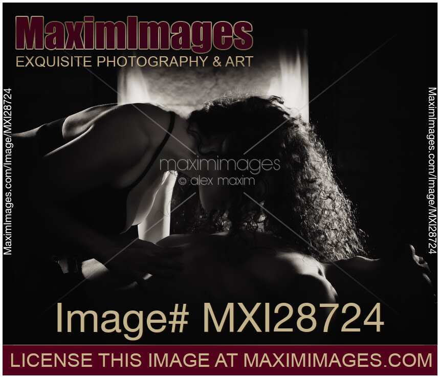 Sensual portrait of a couple making love in front of fireplace Black and white