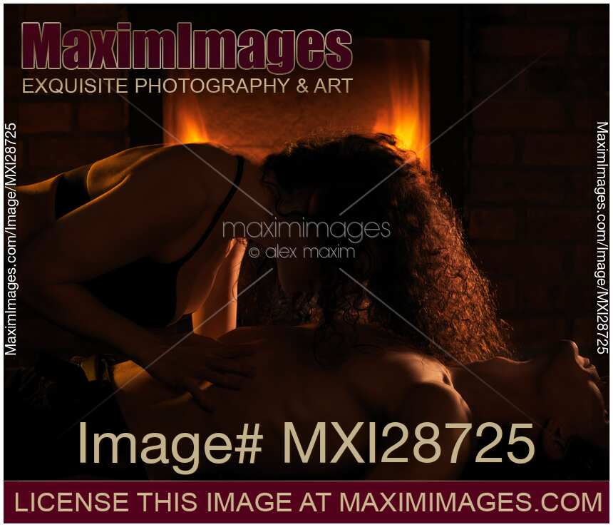 Sensual portrait of a couple making love in front of fireplace