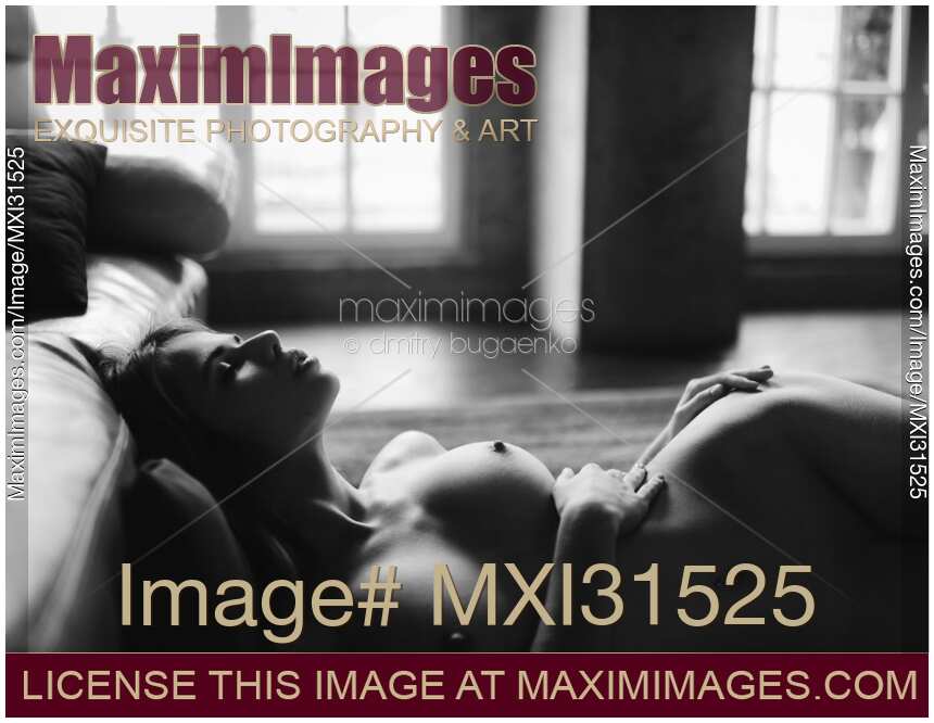 Sensual portrait of a woman lying nude on the floor with closed eyes Black and white