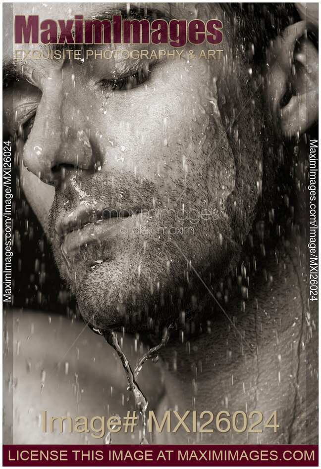 Sensual portrait of man face under pouring water Black and white