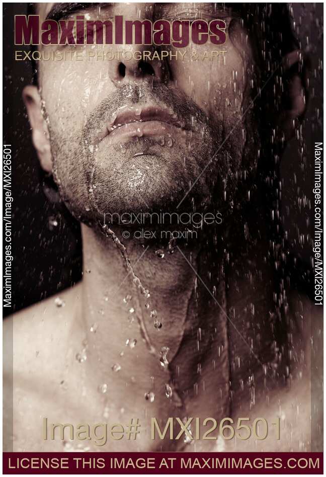 Sensual portrait of man face under shower