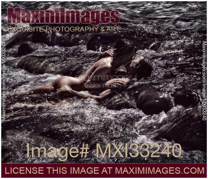 Sensual romantic nude couple in an embrace, kissing, making love in wild water of a river in nature Black and white