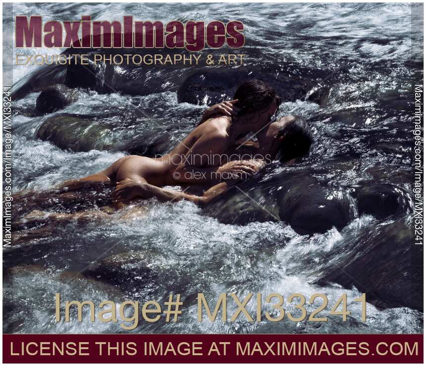 Sensual romantic nude couple in an embrace, kissing, making love in wild water of a river in nature scenery