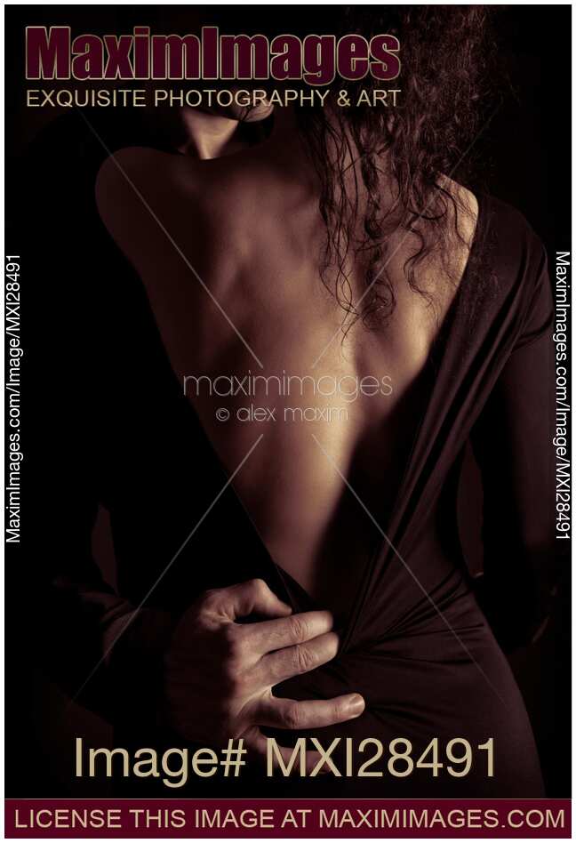 Sensual romantic portrait of a couple kissing in dim dramatic light