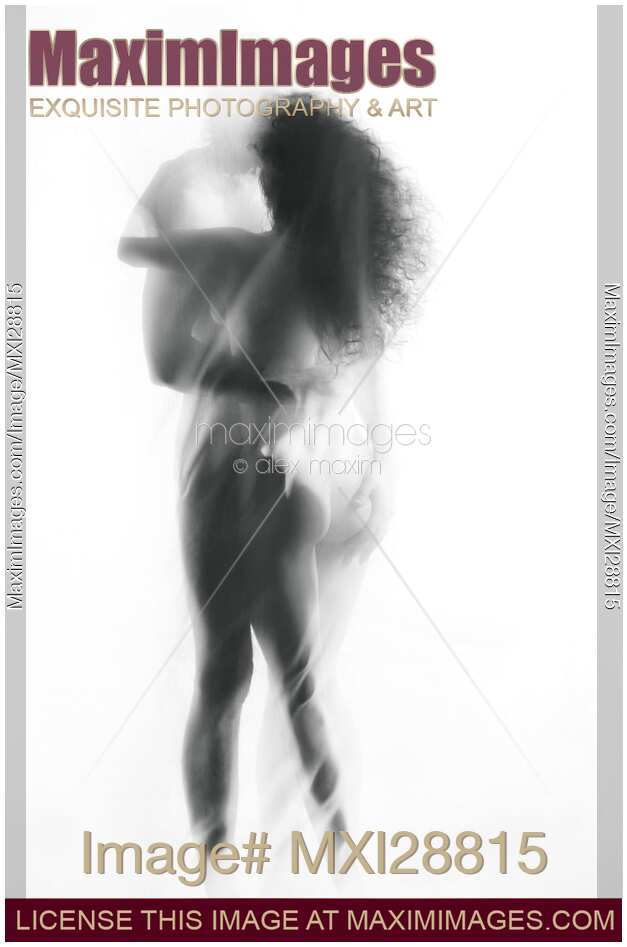 Sensual surreal portrait of a sexy nude kissing couple bodies behind sheer veil