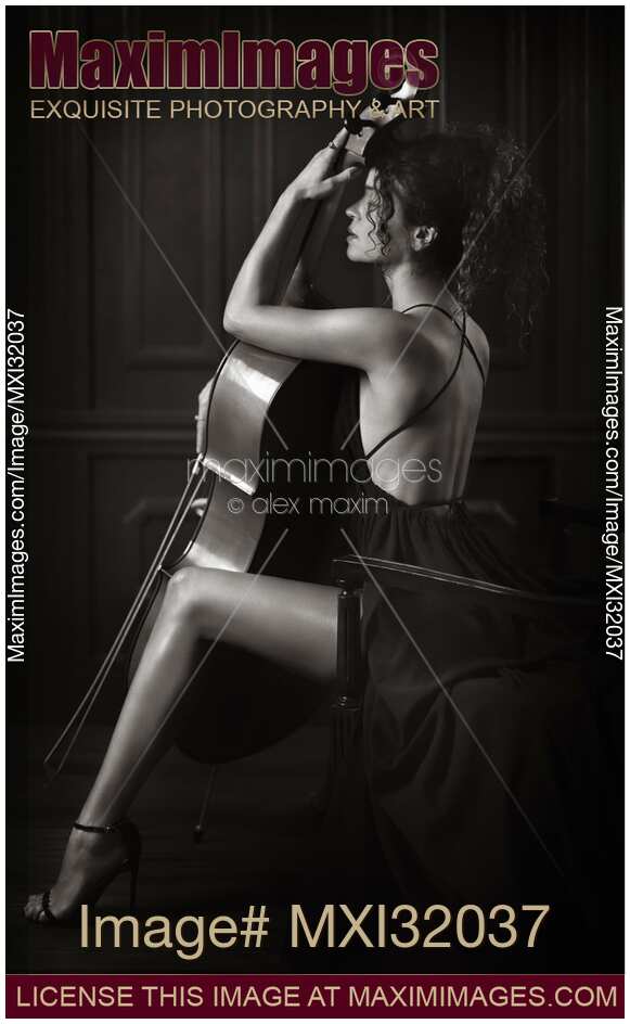 Sensual woman with a cello and a dreamy expression in elegant long dress revealing her legs and back Black and white