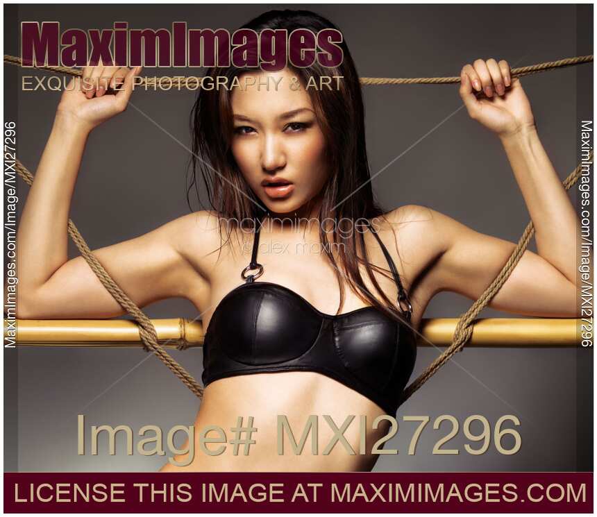 Sexy asian woman in black leather bra