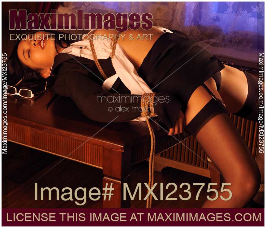 Sexy Asian Woman Tied up on a Table in sensual delight of surrender