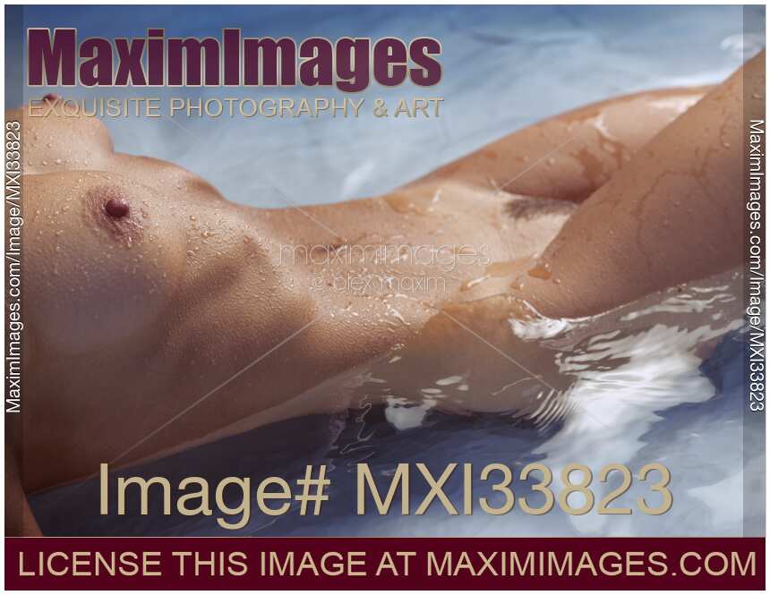 Sexy closeup of nude woman body with wet shiny skin lying in clear blue water of a pool
