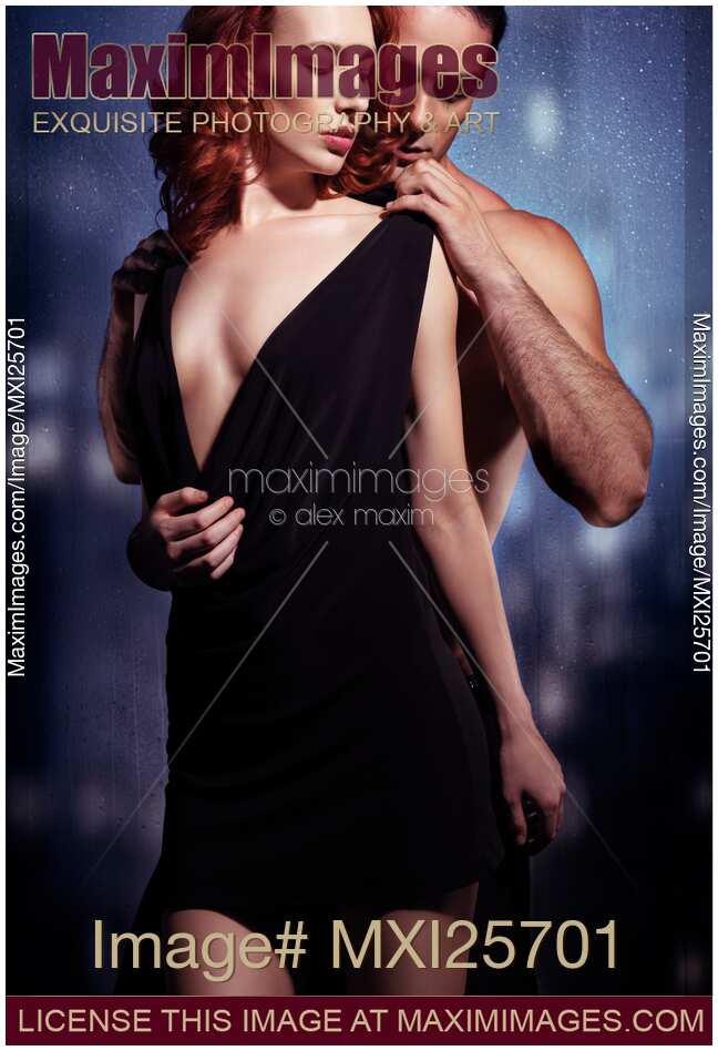 Sexy couple artistic portrait of man undressing woman