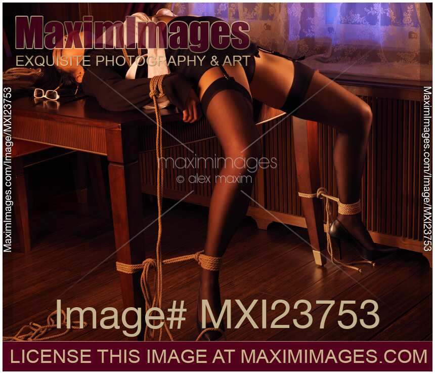 Sexy Japanese Woman Lying tied up on a table in surrender