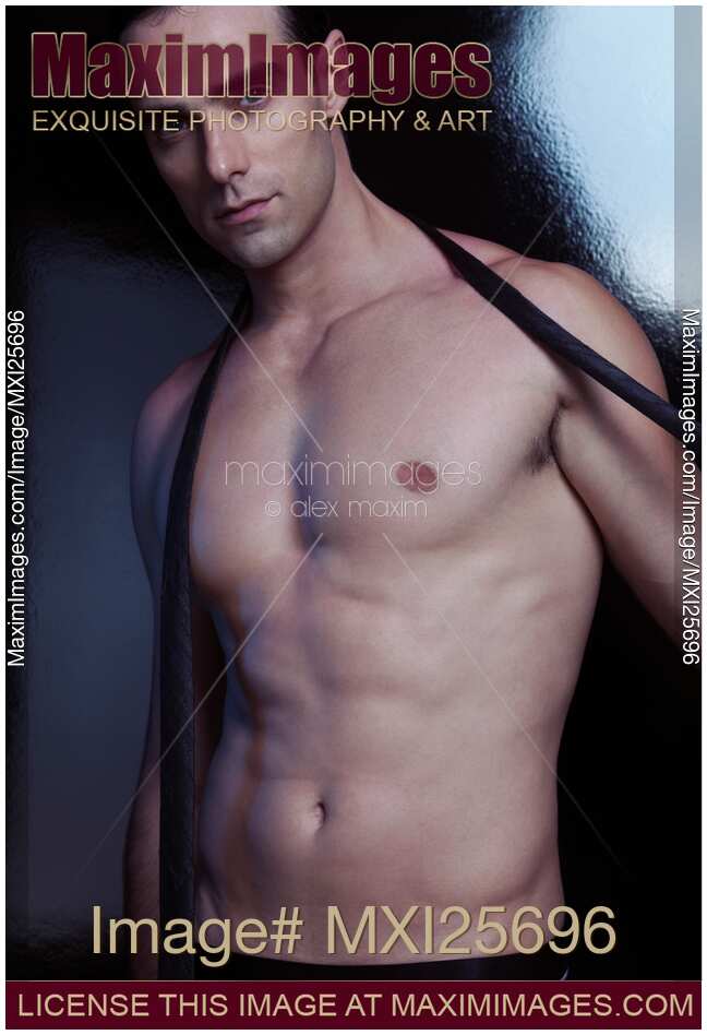 Sexy muscular man taking off necktie