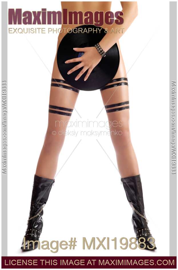 Sexy naked woman in leather boots with vinyl record